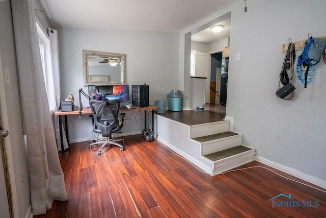 office space with baseboards and wood finished floors
