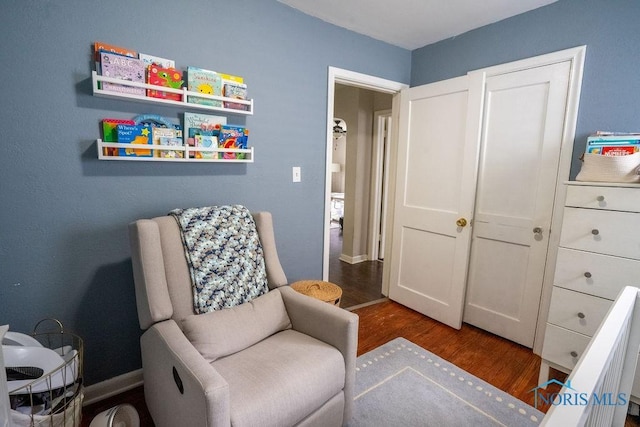 living area featuring baseboards and wood finished floors