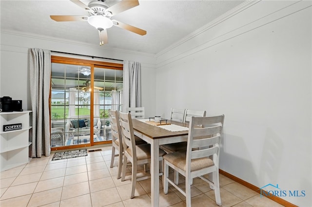 dining area with crown molding, ceiling fan, and light tile patterned floors
