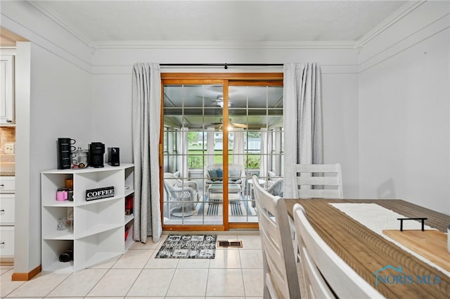dining area featuring light tile patterned floors and ornamental molding