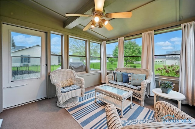 sunroom / solarium with vaulted ceiling with beams and a ceiling fan