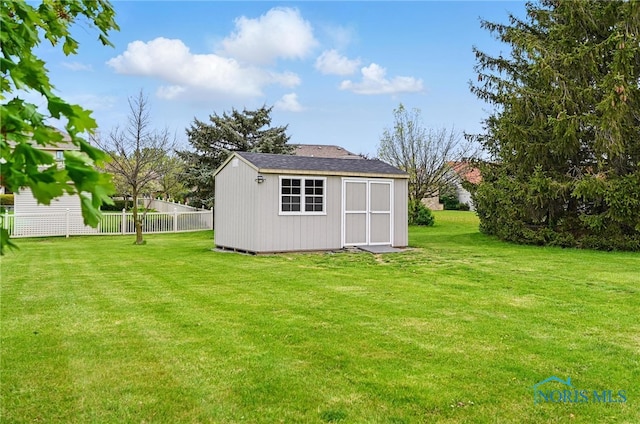 view of shed featuring fence