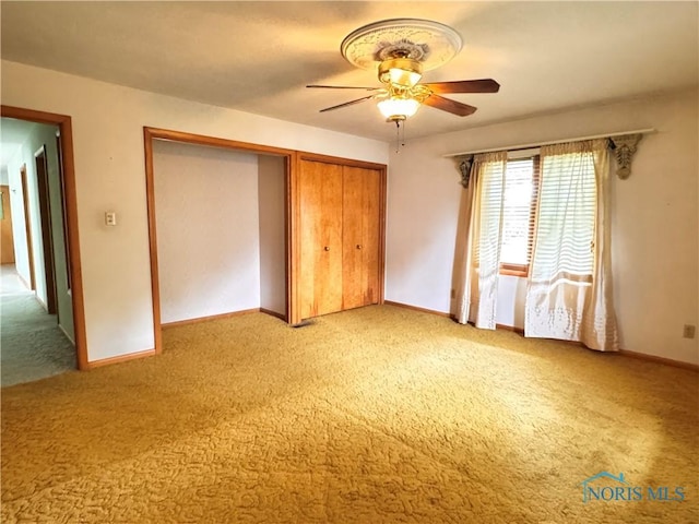 980 E Riverview Ave, Napoleon, OH 43545 - unfurnished bedroom featuring light carpet, a closet, baseboards, and a ceiling fan