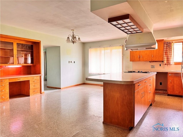 980 E Riverview Ave, Napoleon, OH 43545 - kitchen with light countertops, baseboards, a kitchen island, a chandelier, and black electric cooktop