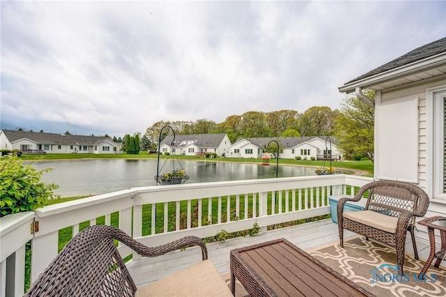 wooden deck with a water view and a residential view