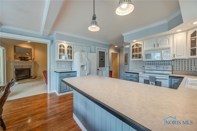 kitchen with crown molding, dark wood-style flooring, white appliances, glass insert cabinets, and backsplash