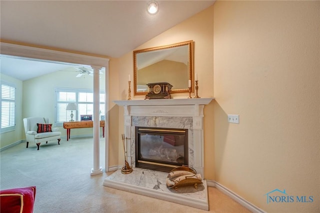 interior space featuring carpet flooring, a premium fireplace, and baseboards