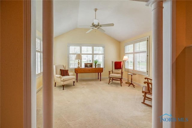 living area with baseboards, a ceiling fan, vaulted ceiling, and light carpet