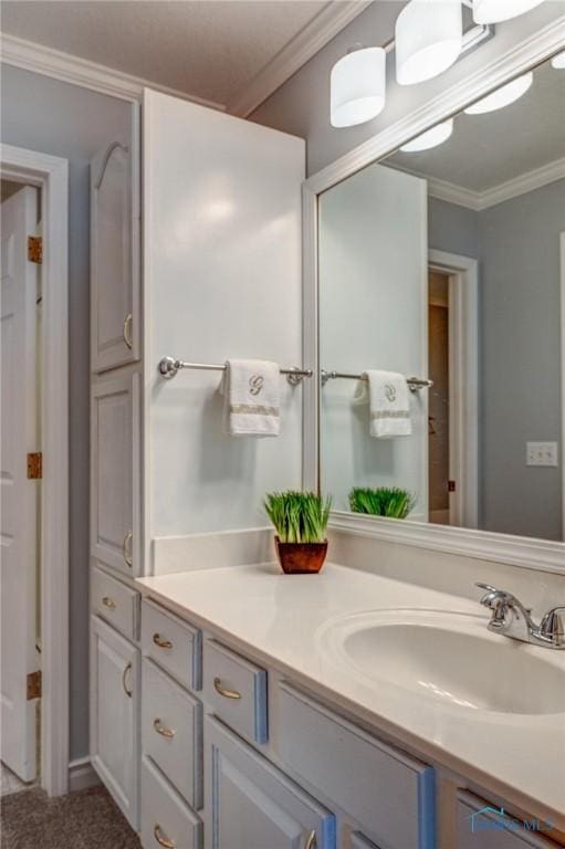 bathroom featuring crown molding and vanity