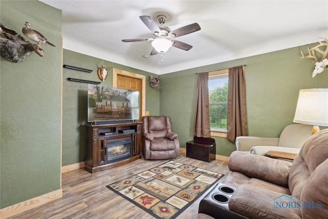 22020 Switzer Rd, Defiance, OH 43512 - living area with a ceiling fan, light wood-type flooring, baseboards, a textured wall, and a fireplace