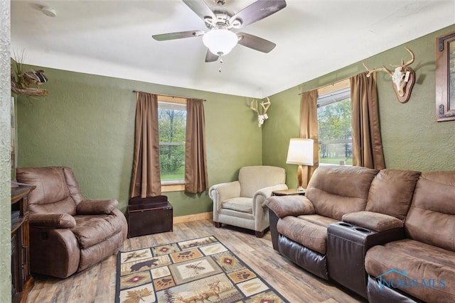 22020 Switzer Rd, Defiance, OH 43512 - living room featuring wood finished floors, healthy amount of natural light, a textured wall, ceiling fan, and baseboards