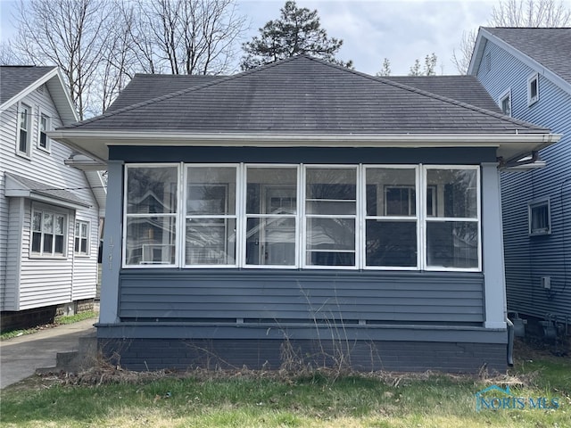 view of side of home featuring a sunroom