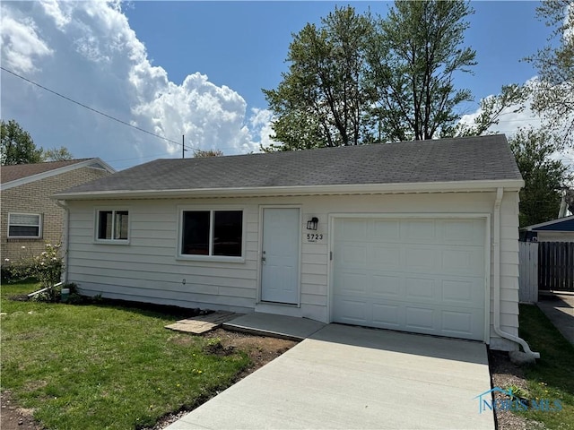 ranch-style house featuring concrete driveway, roof with shingles, fence, and a front yard