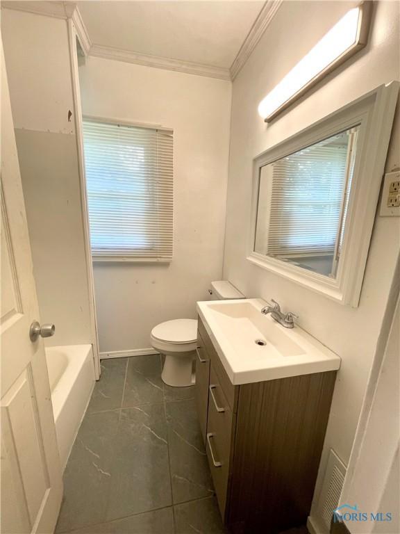 1949 Marlow Rd, Toledo, OH 43613 - full bathroom featuring ornamental molding, vanity, toilet, a tub to relax in, and baseboards