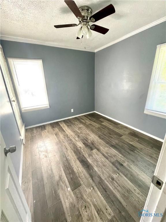 1949 Marlow Rd, Toledo, OH 43613 - empty room with ornamental molding, a textured ceiling, healthy amount of natural light, wood finished floors, and ceiling fan