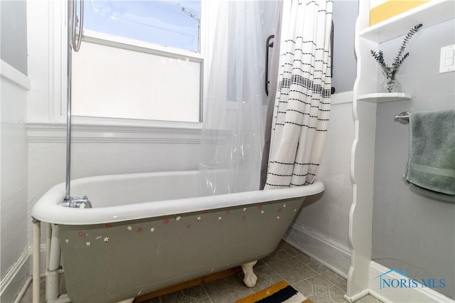 1407 Kenyon Dr, Toledo, OH 43614 - bathroom with a soaking tub, baseboards, and tile patterned floors