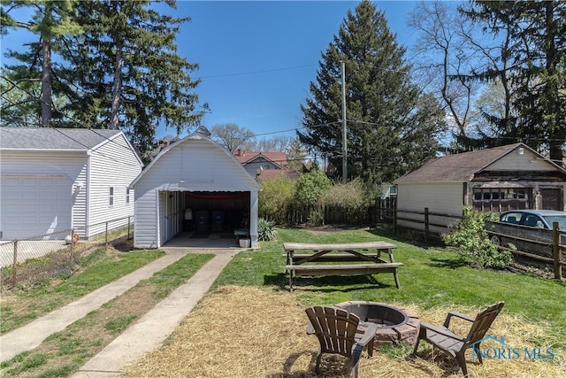 1407 Kenyon Dr, Toledo, OH 43614 - view of yard with a fire pit, a detached garage, and an outbuilding