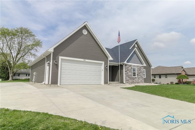749 Parkside Dr, Wauseon, OH 43567 - view of front of property with an attached garage, driveway, stone siding, and a front yard