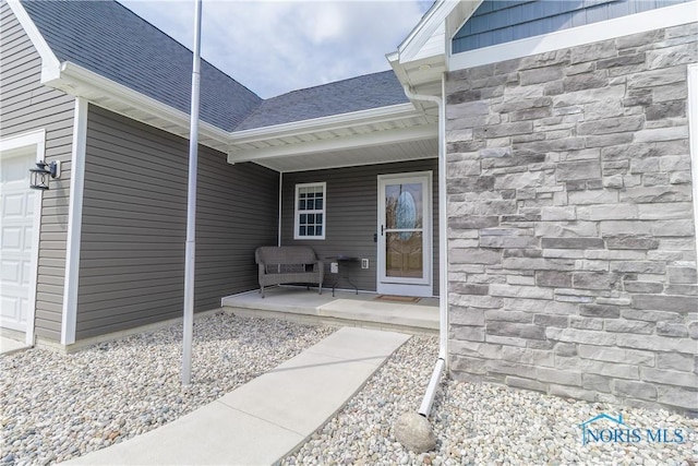 749 Parkside Dr, Wauseon, OH 43567 - doorway to property featuring a garage, a shingled roof, a porch, and stone siding