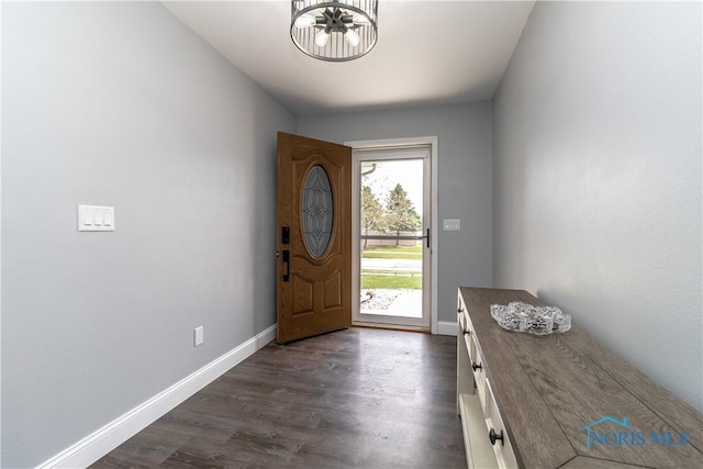 749 Parkside Dr, Wauseon, OH 43567 - entrance foyer with baseboards, dark wood-style flooring, and a notable chandelier
