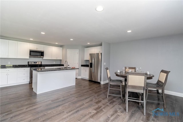 749 Parkside Dr, Wauseon, OH 43567 - kitchen with appliances with stainless steel finishes, dark countertops, a sink, recessed lighting, and white cabinetry