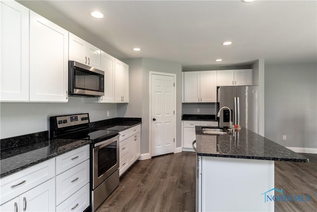749 Parkside Dr, Wauseon, OH 43567 - kitchen featuring appliances with stainless steel finishes, a sink, dark wood finished floors, white cabinetry, and baseboards