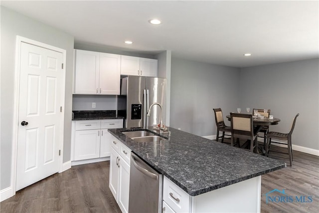 749 Parkside Dr, Wauseon, OH 43567 - kitchen with dark wood-style flooring, stainless steel appliances, white cabinets, and a sink