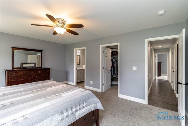 749 Parkside Dr, Wauseon, OH 43567 - bedroom featuring a ceiling fan, baseboards, dark colored carpet, a spacious closet, and ensuite bathroom