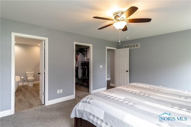 749 Parkside Dr, Wauseon, OH 43567 - carpeted bedroom featuring visible vents, a closet, baseboards, connected bathroom, and a spacious closet
