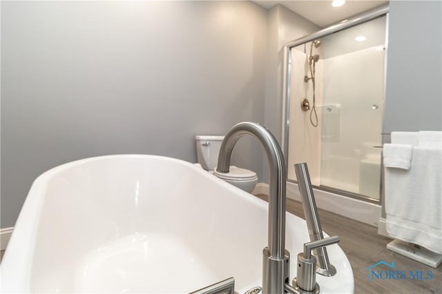 749 Parkside Dr, Wauseon, OH 43567 - room details with wood finished floors, toilet, recessed lighting, a freestanding bath, and a stall shower