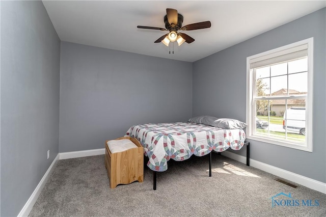 749 Parkside Dr, Wauseon, OH 43567 - carpeted bedroom featuring baseboards, a ceiling fan, and visible vents