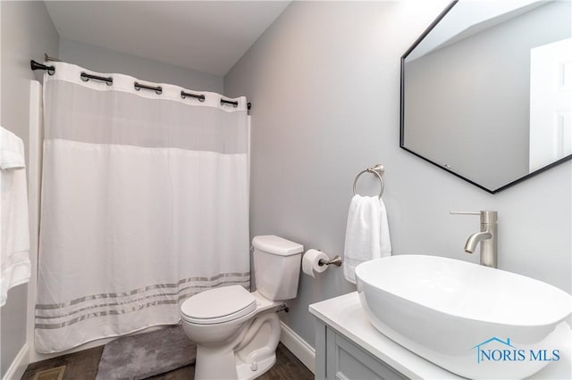 749 Parkside Dr, Wauseon, OH 43567 - full bathroom with baseboards, wood finished floors, toilet, and vanity