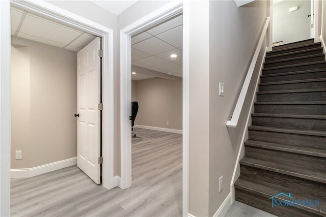 749 Parkside Dr, Wauseon, OH 43567 - stairs featuring baseboards, a paneled ceiling, and wood finished floors