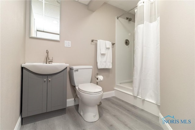 749 Parkside Dr, Wauseon, OH 43567 - bathroom with a shower with shower curtain, toilet, wood finished floors, and vanity
