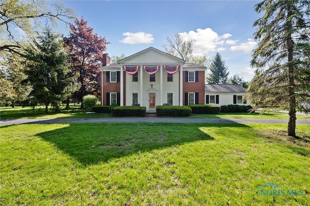 106 N Munson Rd, Swanton, OH 43558 - neoclassical / greek revival house with a front lawn and a chimney