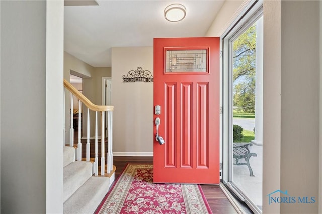 106 N Munson Rd, Swanton, OH 43558 - foyer featuring dark wood-style flooring, stairs, and baseboards