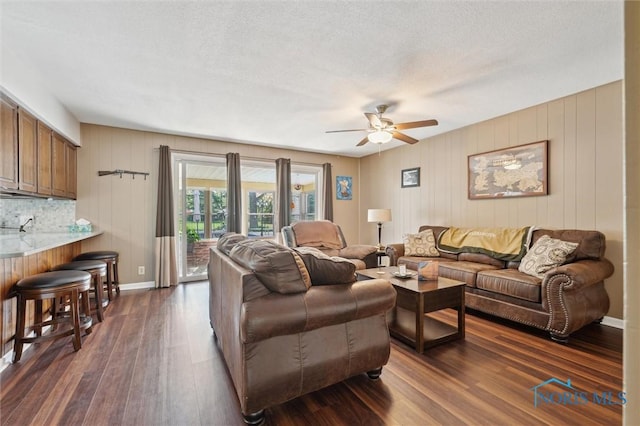 106 N Munson Rd, Swanton, OH 43558 - living area with a ceiling fan, dark wood-style floors, and baseboards