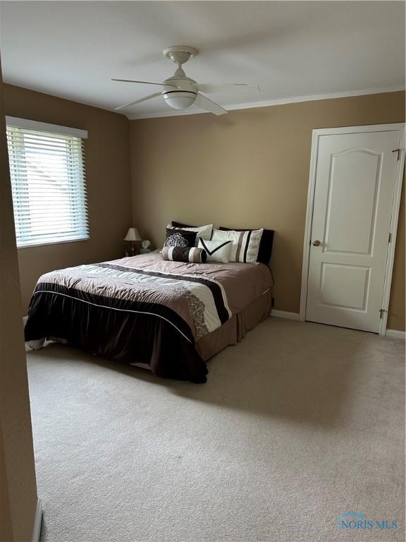 carpeted bedroom featuring a ceiling fan