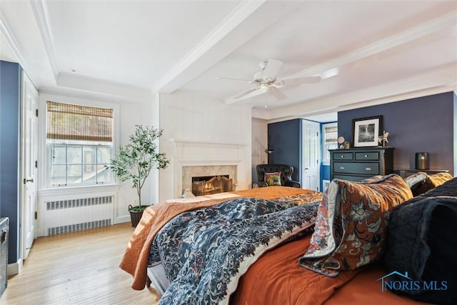 3766 Edgevale Rd, Toledo, OH 43606 - bedroom with radiator, wood finished floors, a fireplace, and ceiling fan