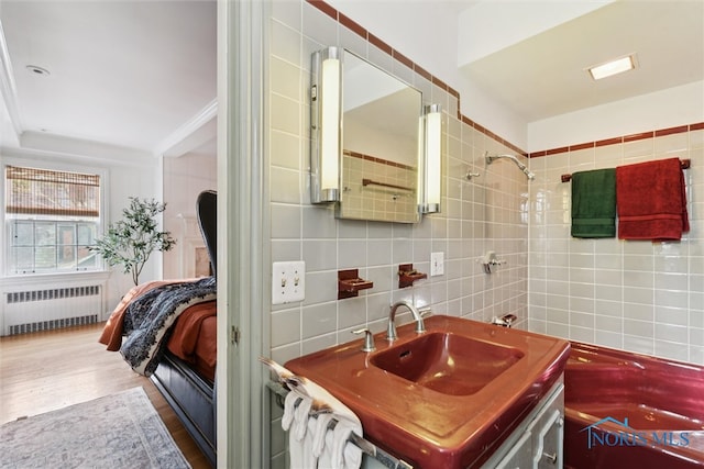 3766 Edgevale Rd, Toledo, OH 43606 - ensuite bathroom with radiator, tile walls, wood finished floors, and vanity