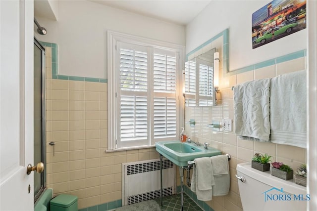 3766 Edgevale Rd, Toledo, OH 43606 - bathroom featuring radiator, tile walls, toilet, an enclosed shower, and a sink
