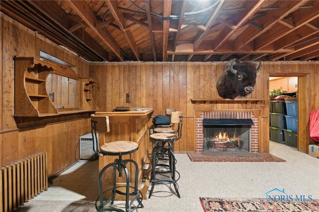3766 Edgevale Rd, Toledo, OH 43606 - indoor bar featuring radiator heating unit, wood walls, a fireplace, and carpet