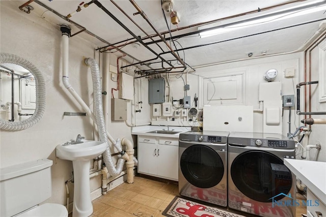 3766 Edgevale Rd, Toledo, OH 43606 - laundry room with washing machine and clothes dryer, cabinet space, and electric panel