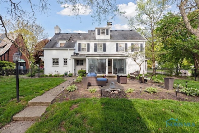 3766 Edgevale Rd, Toledo, OH 43606 - back of property with an outdoor hangout area, a sunroom, a patio area, stucco siding, and a chimney
