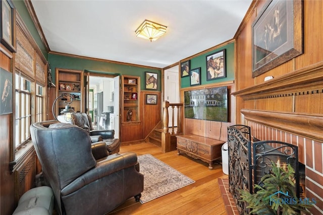 3766 Edgevale Rd, Toledo, OH 43606 - living area with crown molding, light wood-style flooring, stairway, and wood walls