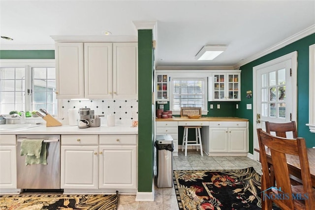 3766 Edgevale Rd, Toledo, OH 43606 - kitchen featuring stainless steel dishwasher, crown molding, white cabinets, a sink, and a desk