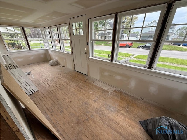 unfurnished sunroom with wood-type flooring