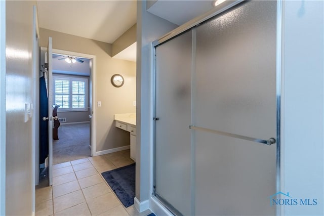 full bathroom with tile patterned flooring, ceiling fan, a stall shower, and vanity