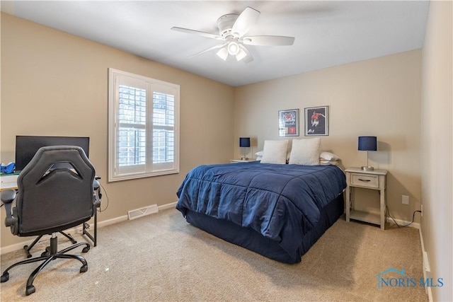 carpeted bedroom with baseboards, ceiling fan, and visible vents