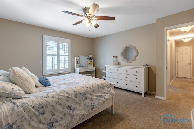 bedroom with light colored carpet, baseboards, and ceiling fan